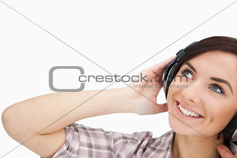 Woman with headphones looking up