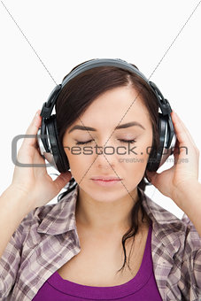 Woman with headphones enjoying music the eyes closed
