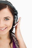 Blue eyed brunette smiling while wearing headphones