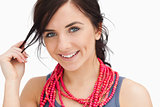 Smiling blue eyed woman with a red bead necklace