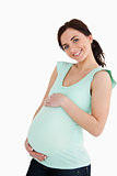 Young pregnant woman smiling at camera