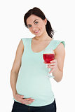 Young pregnant woman holding a mocktail