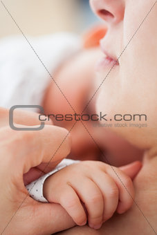 Peaceful woman lying while holding her cute baby