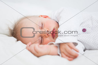 Cute baby sleeping while extending her arms