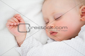Peaceful baby lying on a bed while sleeping