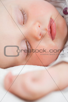 Cute baby lying on a bed while sleeping
