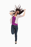 Brunette jumping with her hair in the air