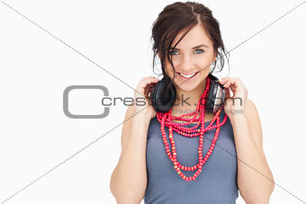 Blue eyed student holding her headphones