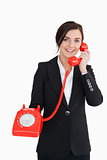 Businesswoman holding an old red phone