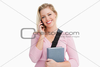 Smiling blonde woman talking on the phone