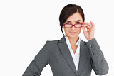 Seductive businesswoman holding her glasses