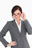 Beautiful young businesswoman holding her glasses