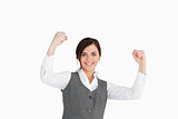 Young woman in suit raising her fists