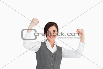 Young woman in suit raising her fists