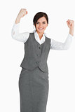 Smiling businesswoman raising her fists