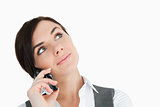 Beautiful businesswoman looking up while phoning
