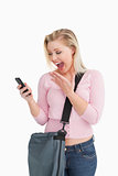 Happy woman showing her surprise while reading a text