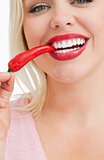 Happy woman eating a red chili pepper