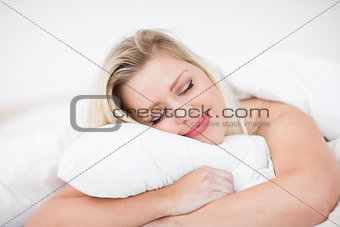 Blonde smiling while sleeping