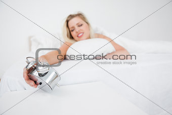 Woman looking at her alarm clock