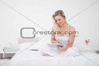 Blonde using an ebook while sitting 