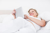 Woman laughing while using an ebook reader