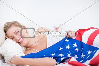 Laughing blonde woman with a US flag