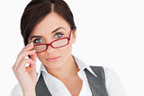 Blue eyed businesswoman holding her glasses