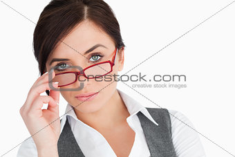 Blue eyed businesswoman holding her glasses
