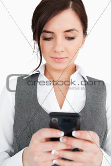 Brunette in suit reading a text-message