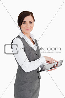 Smiling businesswoman using a touchscreen tablet