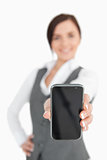 Brunette businesswoman showing her smartphone screen