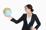 Brunette businesswoman holding an earth globe in her palm