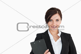 Smiling woman in suit holding a clipboard