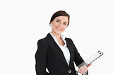 Woman in suit smiling while holding a clipboard