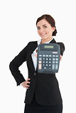 Smiling businesswoman in black suit showing a calculator