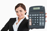 Smiling woman in black suit showing a calculator