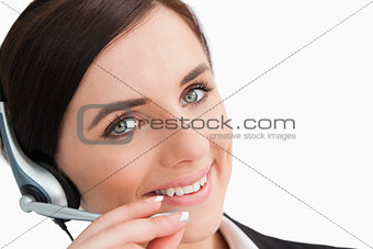 Smiling woman in suit using a headset