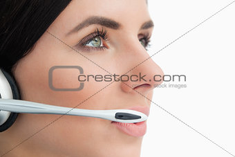 Close-up of a green eyed woman wearing a headset