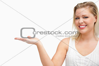 Cheerful woman putting her hand palm up
