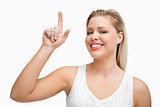 Happy blonde woman pointing her finger up