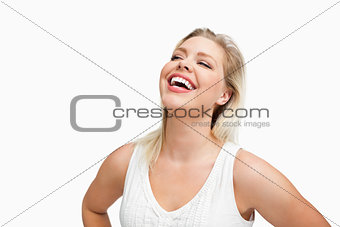 Happy woman laughing with her hands on her hips