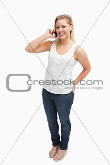Cheerful blonde woman holding her cellphone