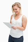 Happy blonde woman holding her tablet computer
