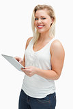 Happy blonde woman using her tablet computer