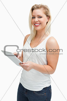 Happy blonde woman using her tablet computer