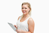 Cheerful blonde woman holding her tablet computer
