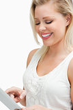 Joyful blonde woman looking at her tablet computer