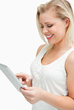 Blonde woman standing while using her tablet computer