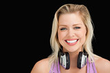 Happy blonde woman standing upright with headphones